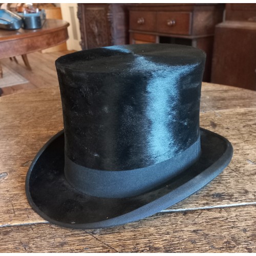 76 - A Lincoln Bennett & Co moleskin top hat in leather box. Front to back measurement 19.5cm, side to si... 