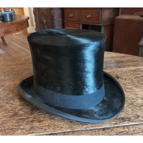 76 - A Lincoln Bennett & Co moleskin top hat in leather box. Front to back measurement 19.5cm, side to si... 