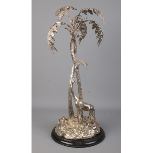 105 - A silverplated centrepiece modelled as a giraffe beneath a tree. Height 50cm.