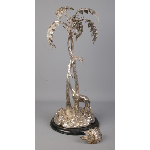 105 - A silverplated centrepiece modelled as a giraffe beneath a tree. Height 50cm.