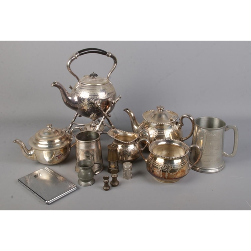 109 - A collection of metalwares. Includes spirit kettle, miniature miners lamp, herbal smelling bottle, S... 
