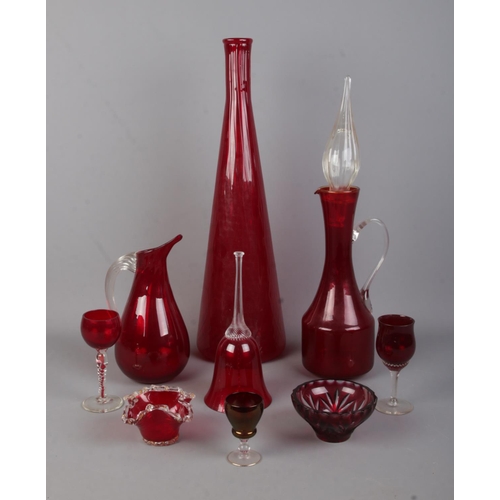 115 - A collection of ruby and red coloured glassware. To include large vase, small goblet with twisted st... 