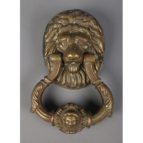 118 - A heavy brass lion mask door knocker. Approx. dimensions 13cm x 19.5cm.