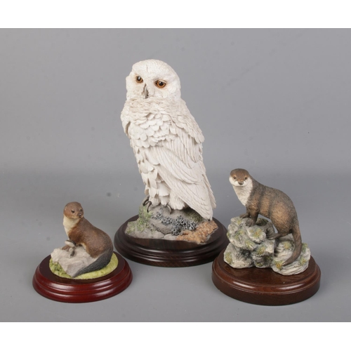 123 - A Country Artists figure of a Snowy Owl, along with two similar otter figures. One by Border Fine Ar... 