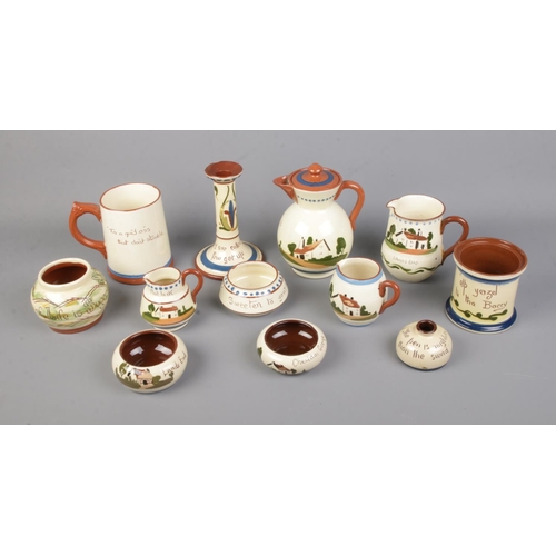 14 - A collection of Torquay/Motto ware ceramics to include jug, tankard, candlestick, etc.