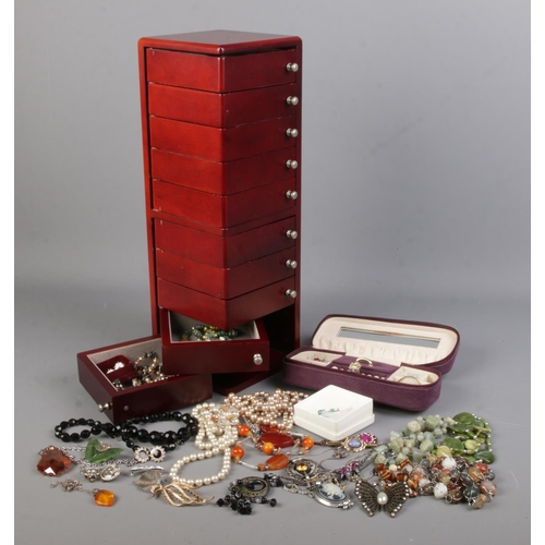 144 - A jewellery tower and small jewellery case with contents of costume jewellery. Includes fine 9ct gol... 