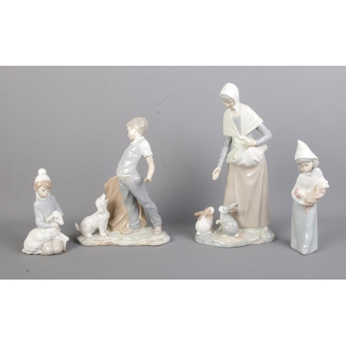 146 - A collection of Lladro and Nao by Lladro figures, with boxes. To include boy with dog and woman feed... 