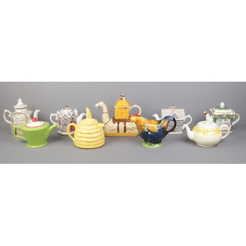 15 - A collection of novelty teapots, to include Tony Wood camel and Sadler examples containing Elizabeth... 