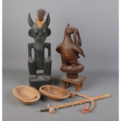 154 - A collection of tribal items. Includes carved figure (43cm), carved eagle and snake, shark tooth wea... 