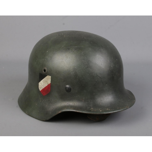 165 - A German World War Two M40 steel helmet.