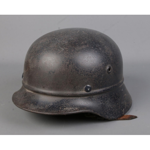 166 - A German World War Two beaded helmet.