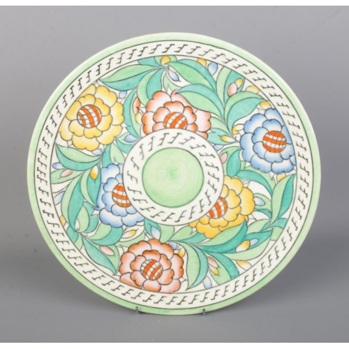 24 - A Charlotte Rhead for Crown Ducal ceramic charge decorated in a floral pattern. Approx. diameter 32.... 