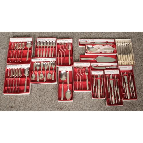 55 - A large collection of boxed flatware, mainly Community Plate Includes knives and forks, spoons and p... 