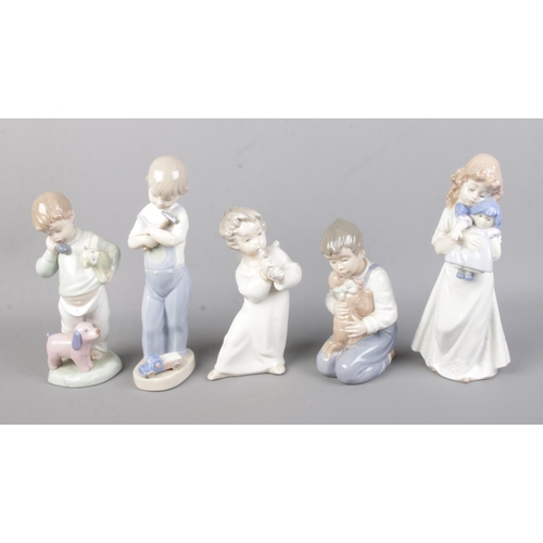 67 - A collection of Lladro and Nao by Lladro ceramic figures to include cherub playing flute, boy with d... 