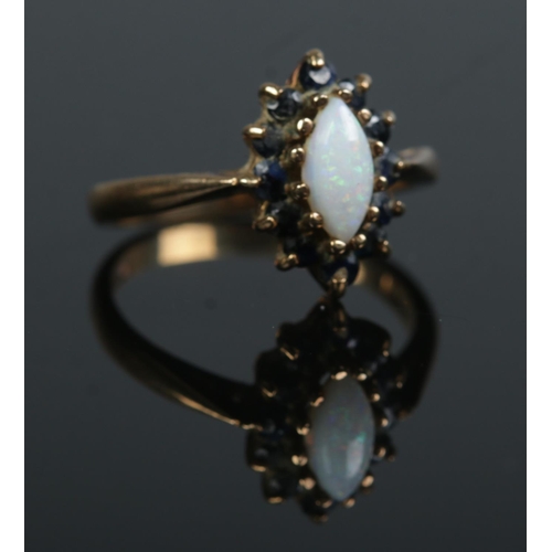 474 - A 9ct gold, opal and sapphire ring. Size N 1/2. 3.1g.