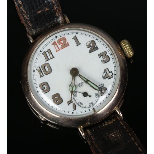 480 - A 9ct gold cased trench wristwatch featuring enameled face and leather strap.