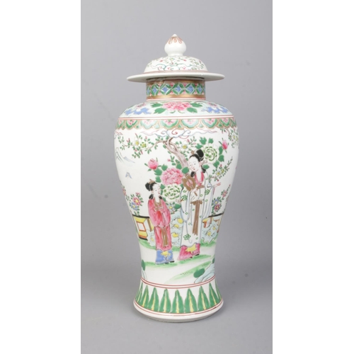 74 - A Chinese Famille Vert lidded baluster vase with coloured enamels, depicting figures in conversation... 