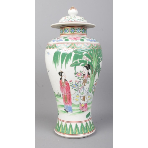 74 - A Chinese Famille Vert lidded baluster vase with coloured enamels, depicting figures in conversation... 