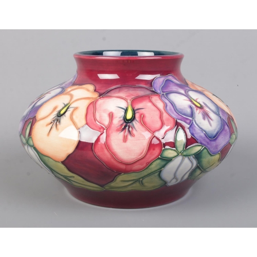 491 - A Moorcroft pottery vase of squat form decorated in the Pansy pattern. Date cypher for 1996. Height ... 