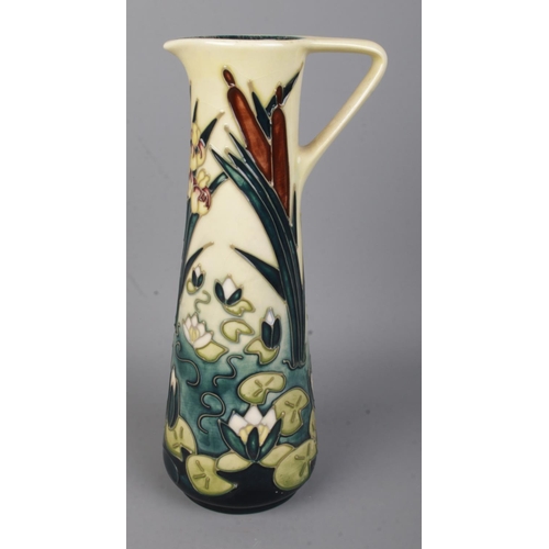 492 - A Moorcroft jug decorated in the Lamia pattern featuring water lilies and bullrushes, dated for 1998... 