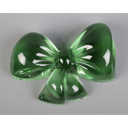 494 - A Baccarat glass paperweight formed as a bow; in Lalique box. Etched to side and to base. 11cm wide.