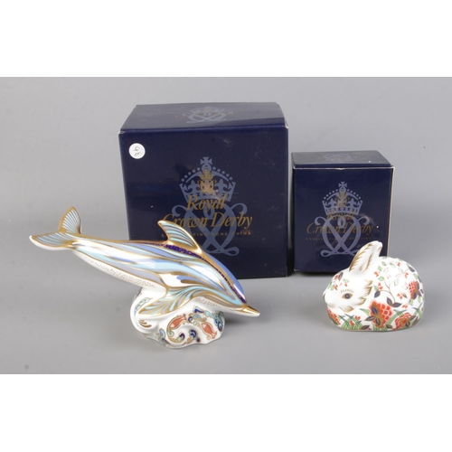 505 - Two boxed Royal Crown Derby paperweights to include Meadow Rabbit and Striped Dolphin. Both with sto... 