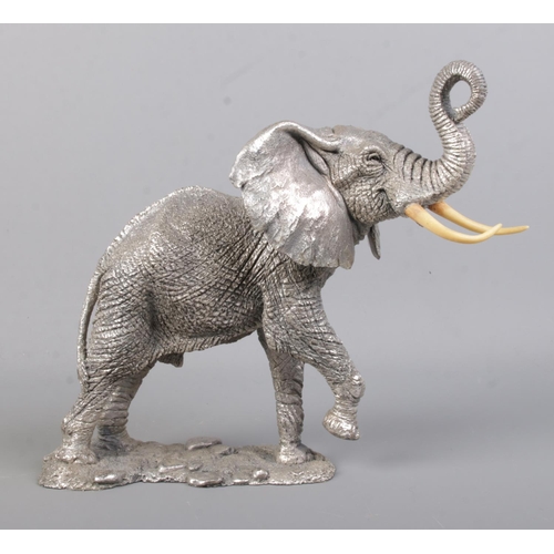 506 - A detailed silver filled model of an African Elephant, by Country Artists, set on naturalistic base.... 