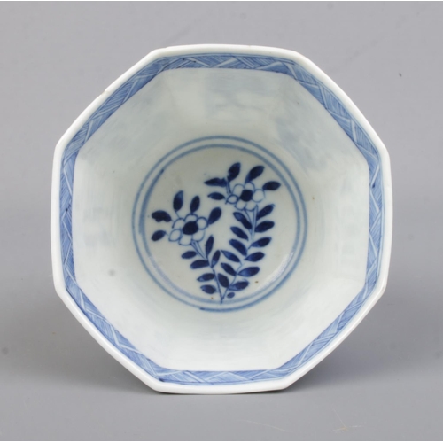 507 - A 19th Century Chinese blue and white cup of octagonal form, depicting plants and figures. Bears con... 