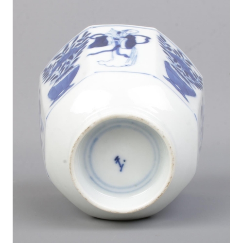 507 - A 19th Century Chinese blue and white cup of octagonal form, depicting plants and figures. Bears con... 