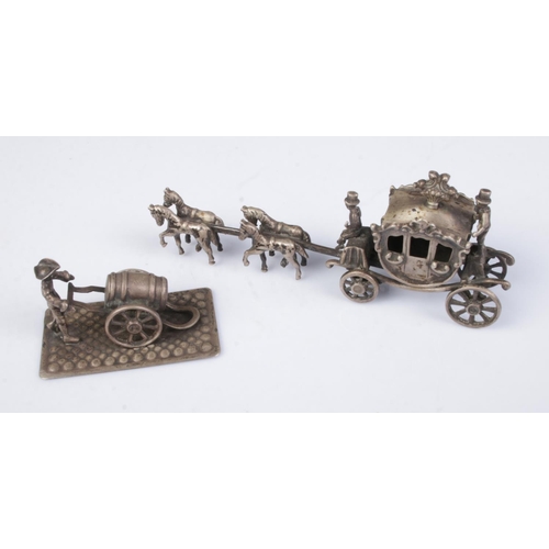 509 - Two Dutch silver miniatures in the form of a horse drawn carriage and a man pushing a barrel. Each b... 