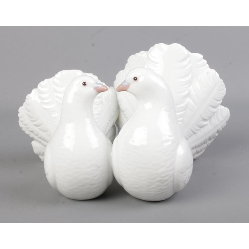 517 - A Lladro figure formed as two doves. Impressed 1169 to base.