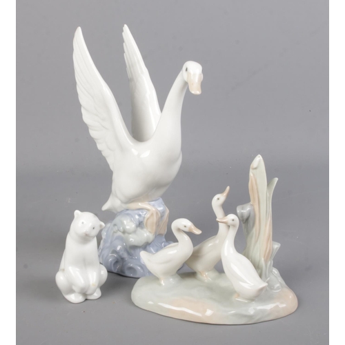 518 - Three Nao ceramic figures. Includes swan in flight, polar bear and duck group.