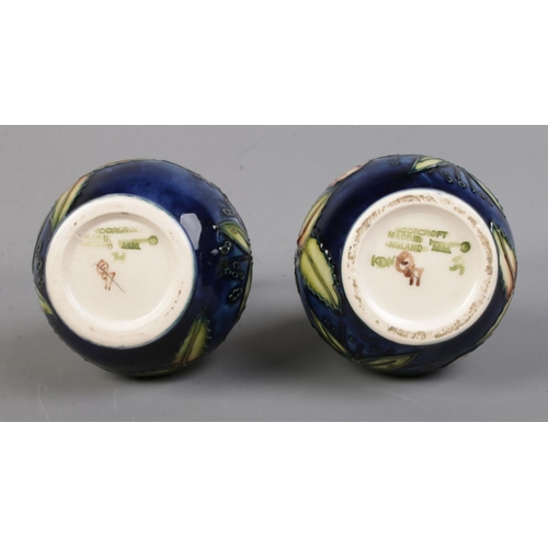 523 - A pair of Moorcroft Pottery slender neck vases, in the 'Sweet Briar' pattern. Date cipher for 2000. ... 