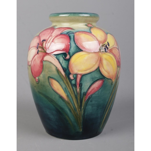 524 - A Walter Moorcroft (1947-1953) pottery vase decorated in the 'African Lilies' pattern. Bearing signa... 