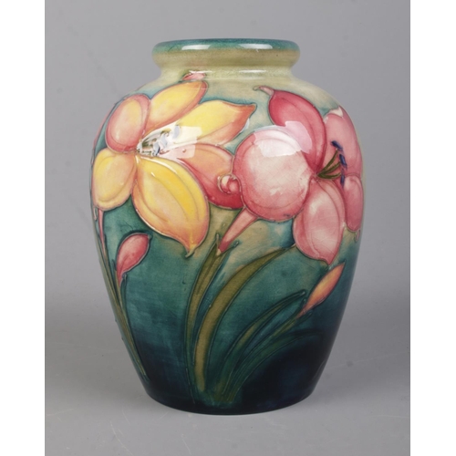 524 - A Walter Moorcroft (1947-1953) pottery vase decorated in the 'African Lilies' pattern. Bearing signa... 