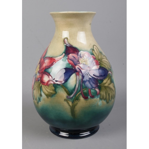 529 - A Walter Moorcroft (1947-53) Pottery vase with blue/ground in the Clematis pattern. Bearing signatur... 