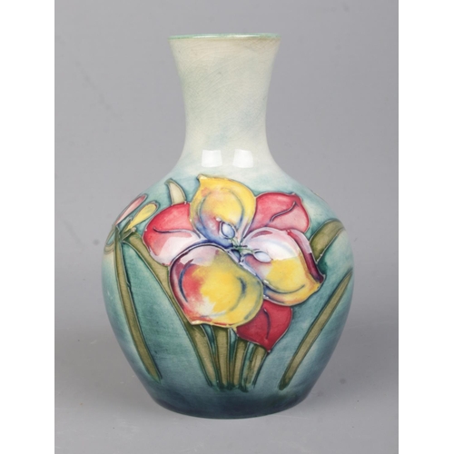 530 - A Moorcroft Pottery (1953-78) slim neck vase in the 'Freesia' pattern. Bearing sticker to the base '... 