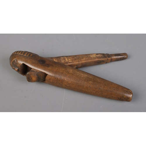 540 - An antique carved treen nutcracker.