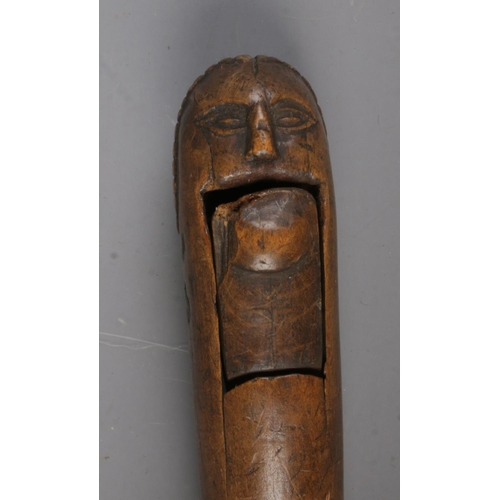 540 - An antique carved treen nutcracker.