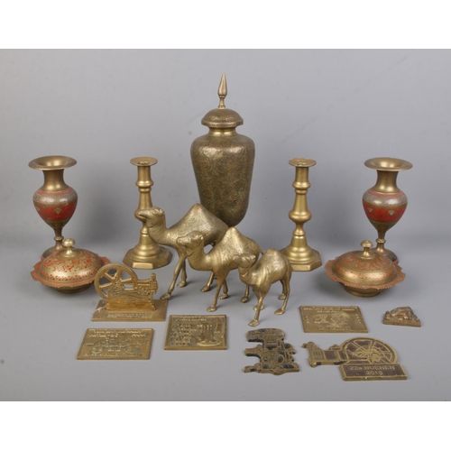 87 - A collection of brass wares, to include a pair of candlesticks, lidded trinket dishes, graduated cam... 