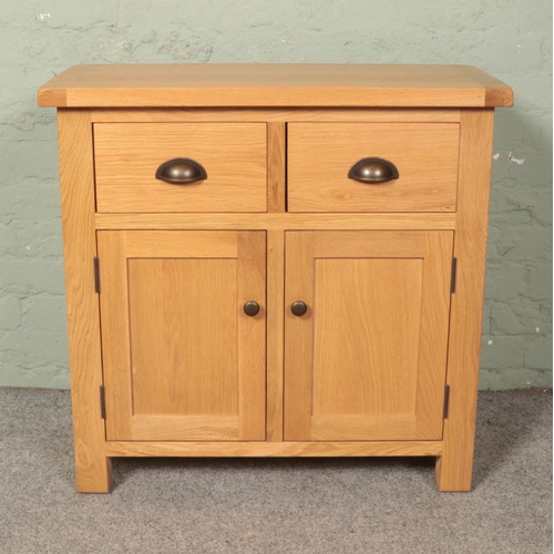 593 - An oak veneer 'mini' sideboard; Sherbourne. Height: 78cm, Width: 80cm, Depth: 35cm.