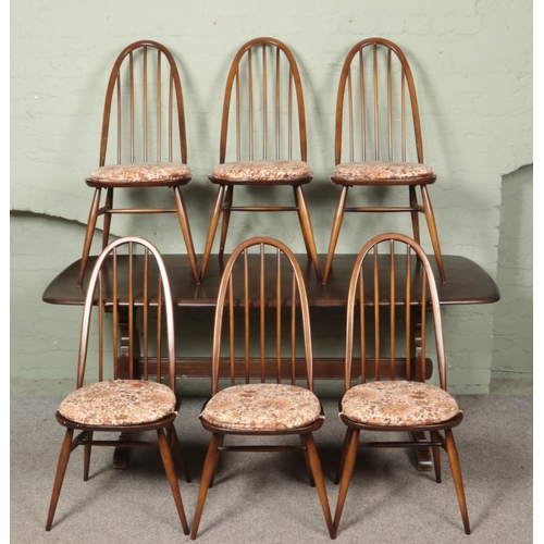 594 - An Ercol 'Old Colonial' refectory dining table, with six quaker back dining chairs. Dimensions of ta... 