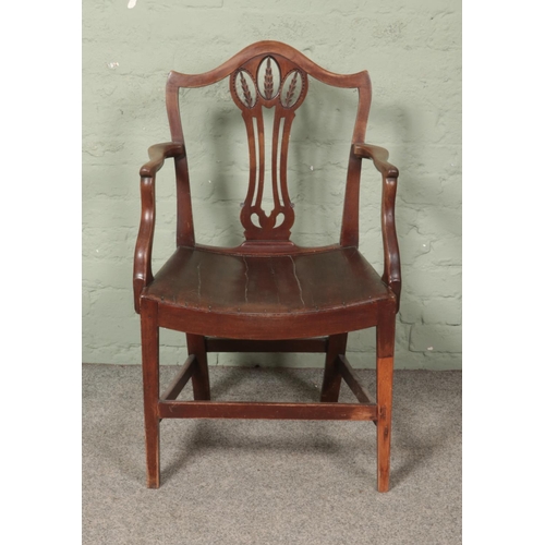 598 - A Georgian mahogany elbow chair, with barrel base and wheat splat.