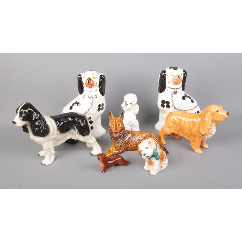 9 - A collection of ceramic dog figures to include Goebel, Arthur Wood and Eastgate examples.