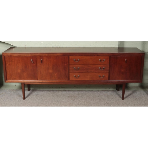 612 - A vintage G-Plan E.Gomme sideboard, with cupboard doors and three drawers. Height: 78cm, Width: 218c... 
