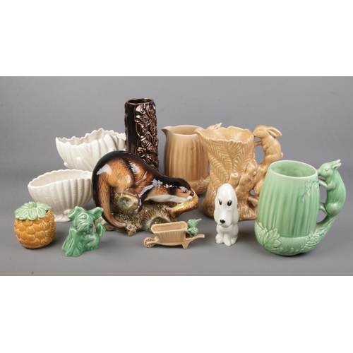 11 - A collection of Sylvac ceramics including otter, vases, dog, pineapple pot etc