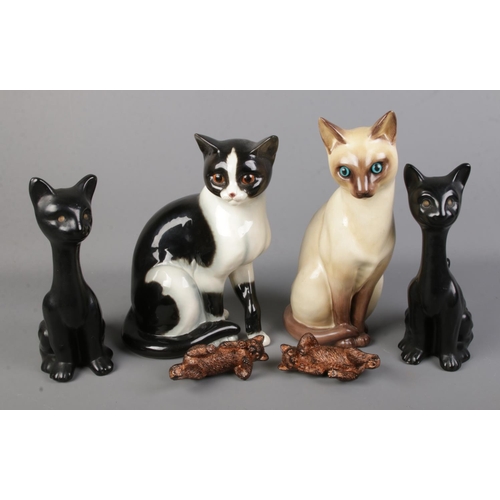 111 - A ceramic Goebel cat together with a quantity of other cat figures.