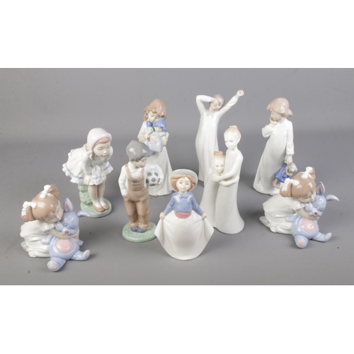 131 - A collection of nine Nao figurines.