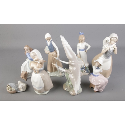 133 - A collection of seven Nao figurines with one Lladro figure of a duck.