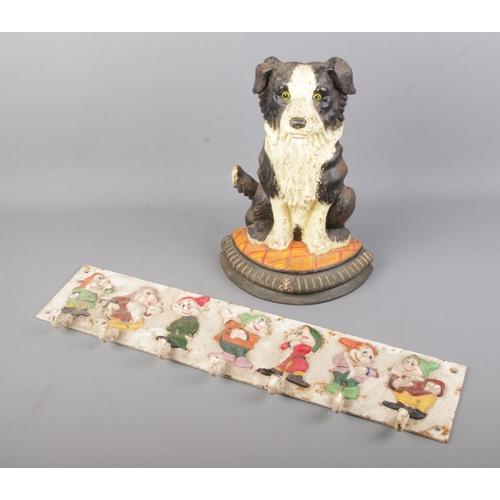 69 - A painted cast iron door stop in the form of a dog together with a cast iron coat rack